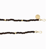 Close-up of the La Coque Française Gaby phone chain's chocolate brown wooden beads, gold-tone spacers and clasps.