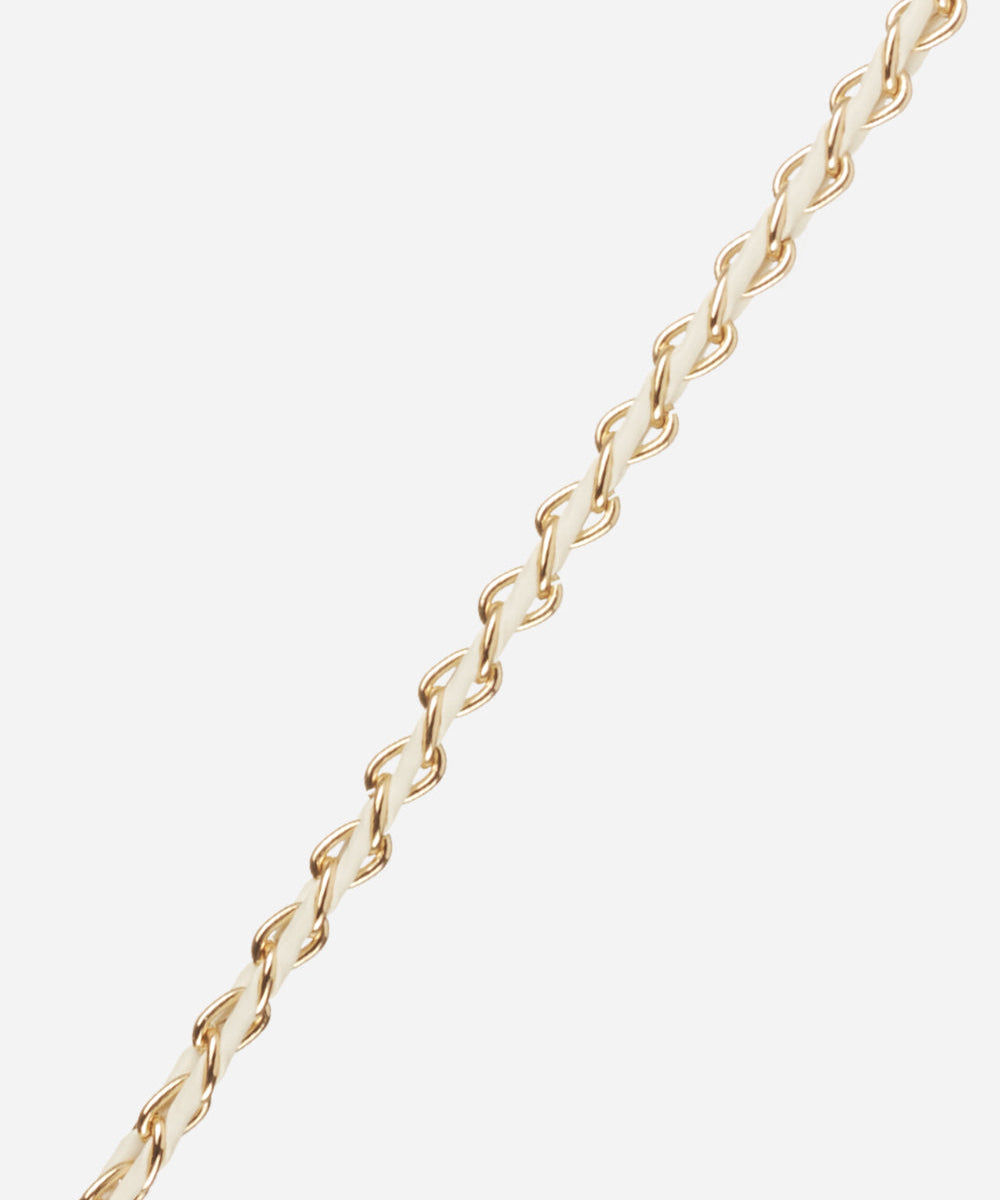 Close-up of the La Coque Française Lou braided phone chain in white and gold