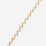 Close-up of the La Coque Française Lou braided phone chain in white and gold