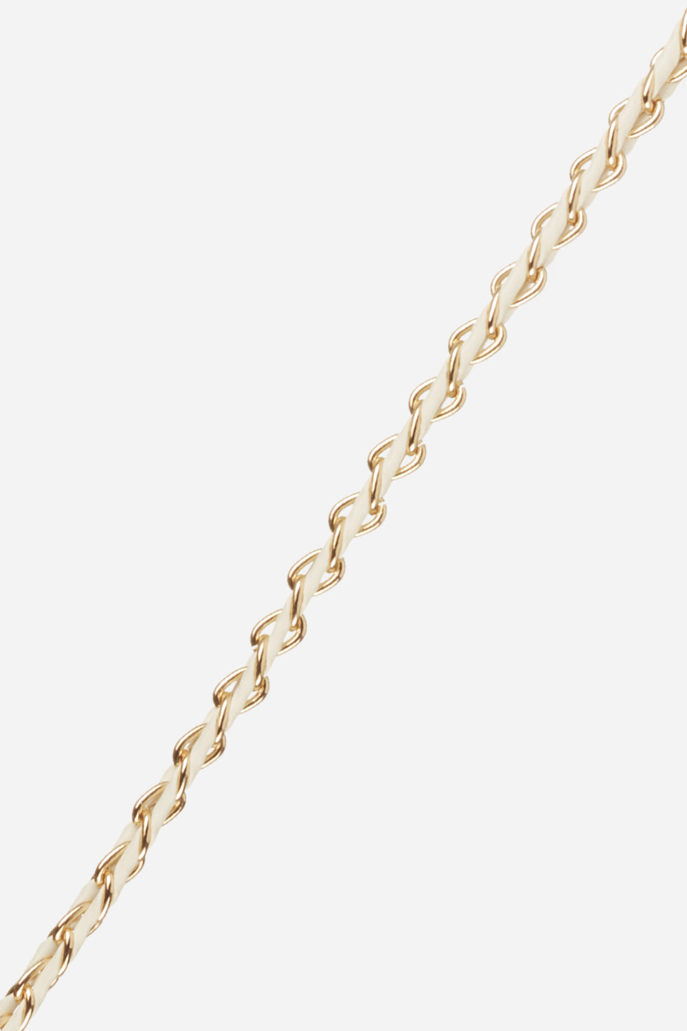 Close-up of the La Coque Française Lou braided phone chain in white and gold