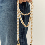 La Coque Française Lou white and gold braided phone chain held with jeans