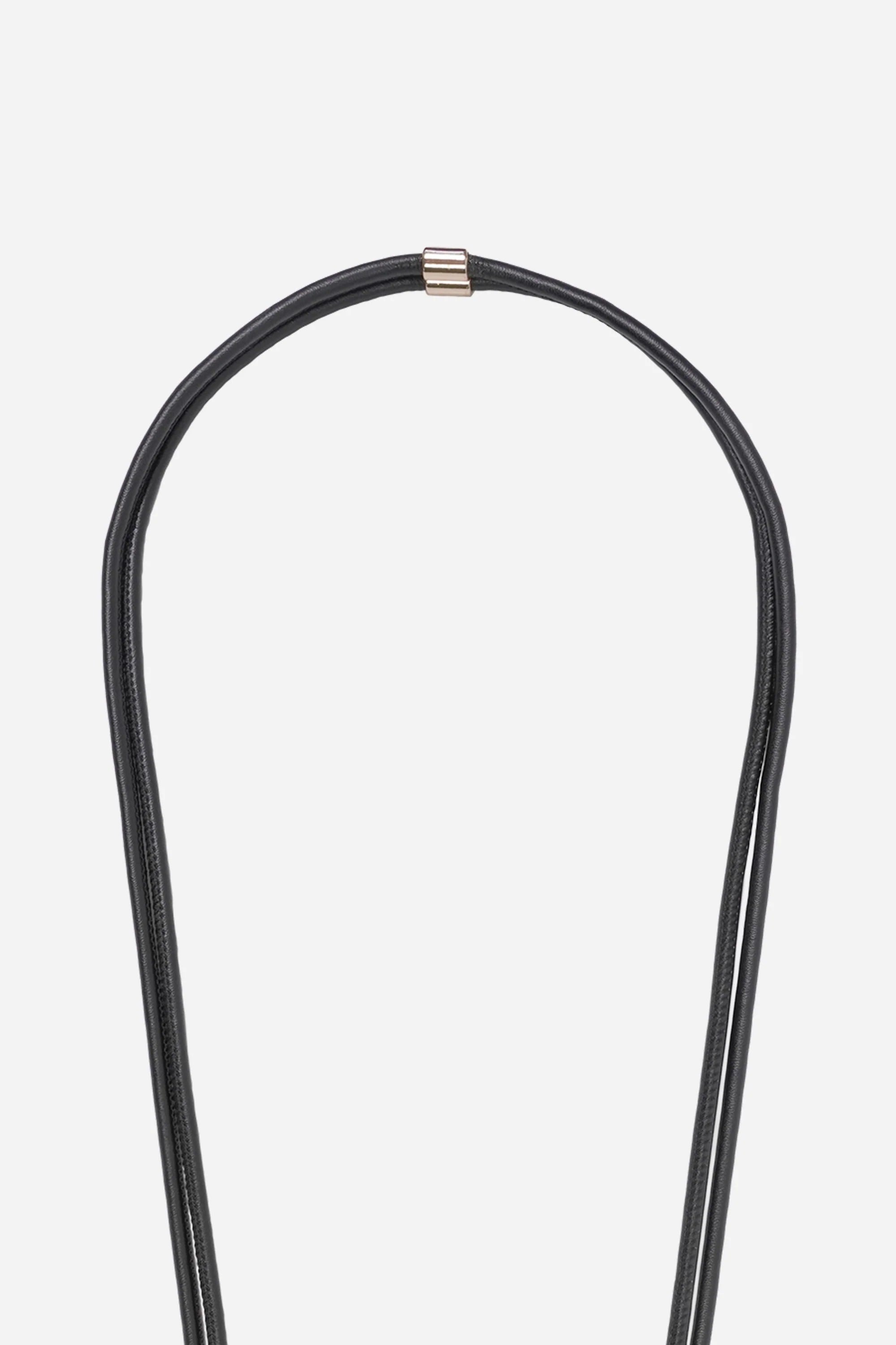 Detail of the gold-tone hardware and signature logo charm on the Nathan black vegan leather strap