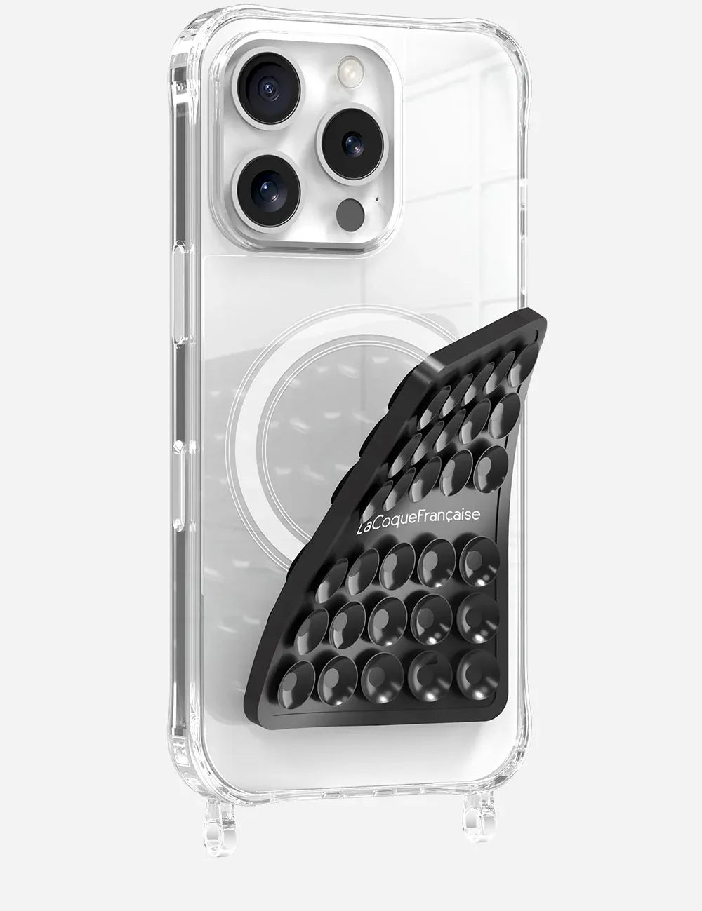 Black La Coque Française Stick-Anywhere Phone Pad applied to a clear phone case for hands-free use.