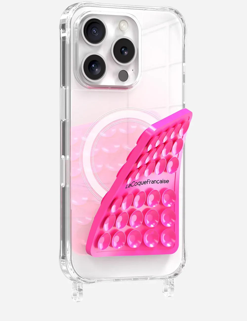Close-up of a neon pink La Coque Française suction pad being applied to a clear smartphone case to show its flexible silicone design