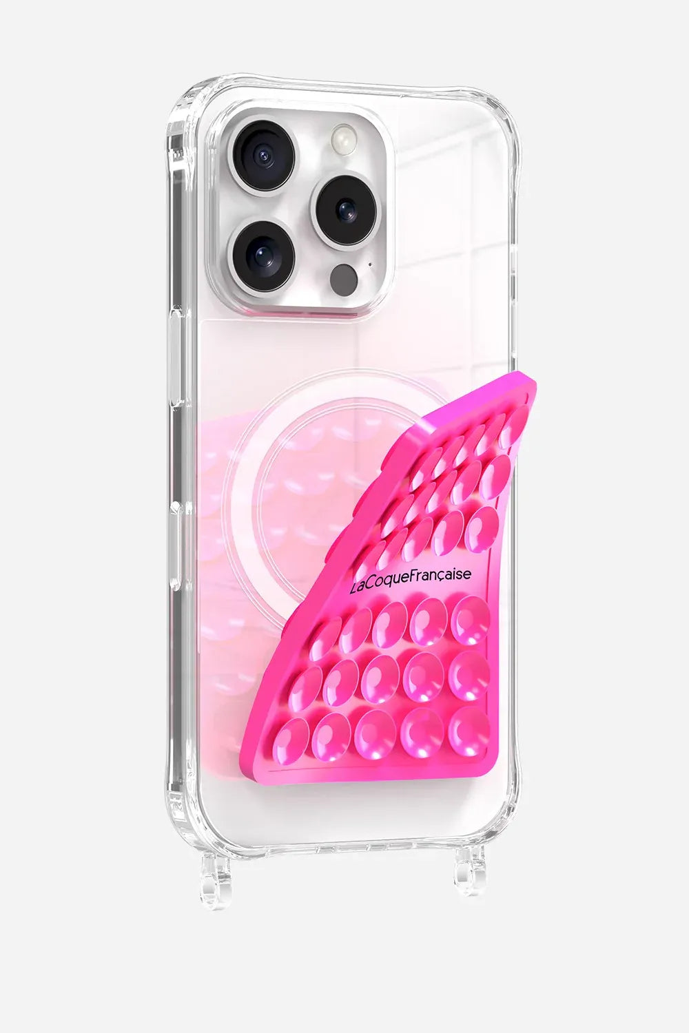 Close-up of a neon pink La Coque Française suction pad being applied to a clear smartphone case to show its flexible silicone design