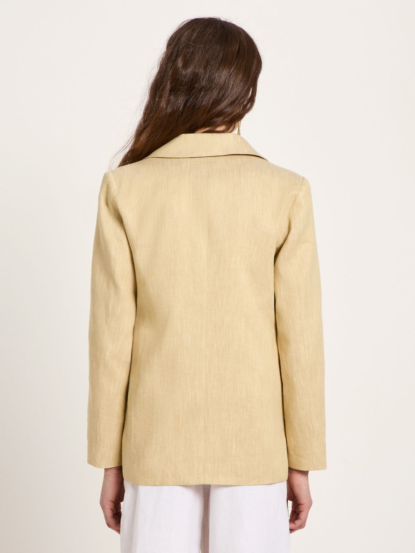 Clean back view of the LANIUS blazer in khaki-creme, showcasing the elegant fall, straight cut, and smooth drape of the sustainable design.