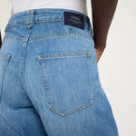 Close-up of the back pocket and mid-rise waistband on Lanius organic blue denim jeans, GOTS certified