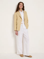 style inspiration showing the slightly longer length of the khaki-creme linen-blend blazer paired with wide-leg white linen trousers for a fluid silhouette.