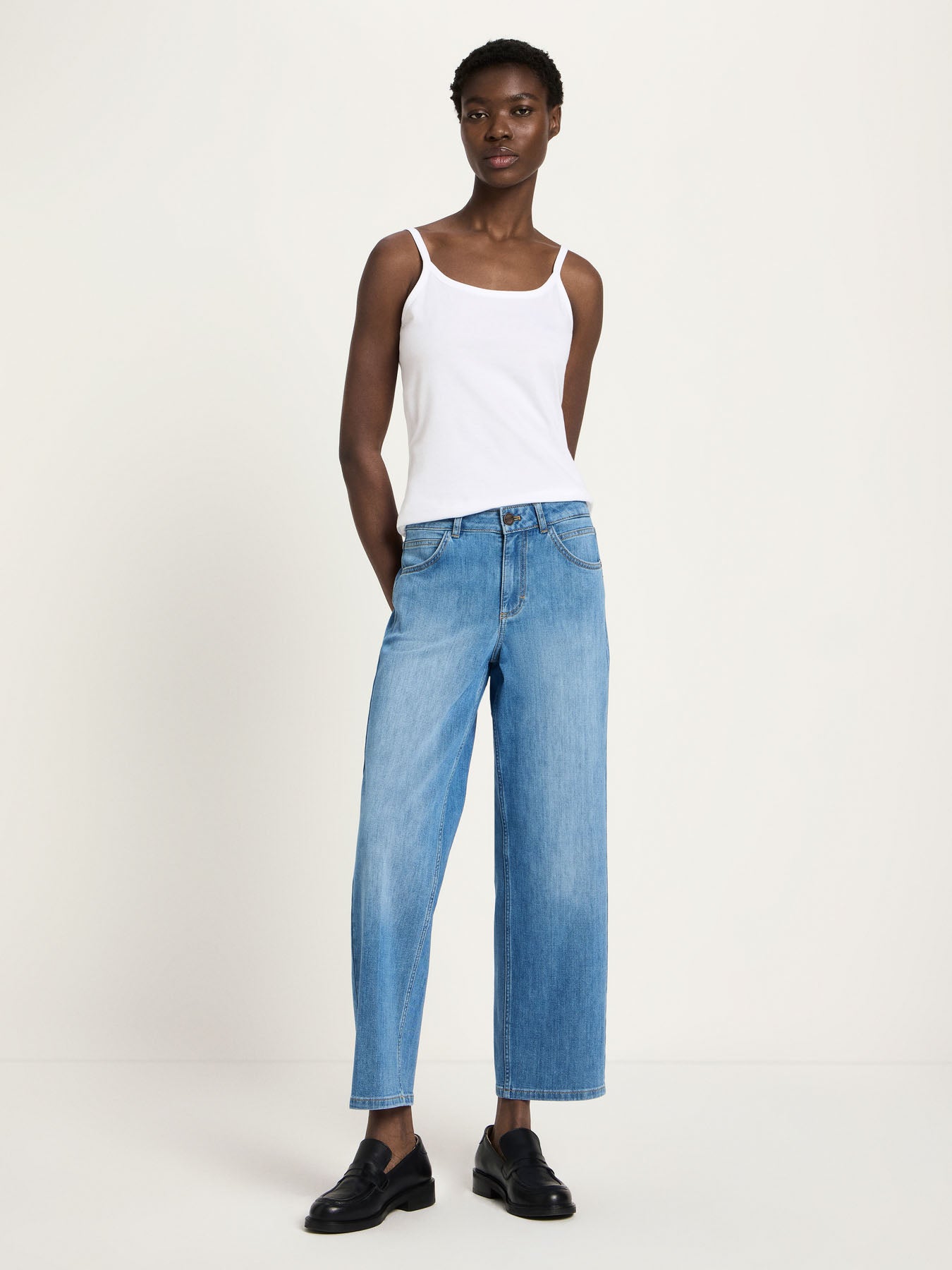 Woman wearing Lanius relaxed fit organic cotton jeans in mid blue, showing the straight wide-leg silhouette