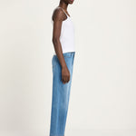 Side profile of a woman wearing Lanius cropped wide-leg jeans in blue, styled for a relaxed sustainable luxury look.