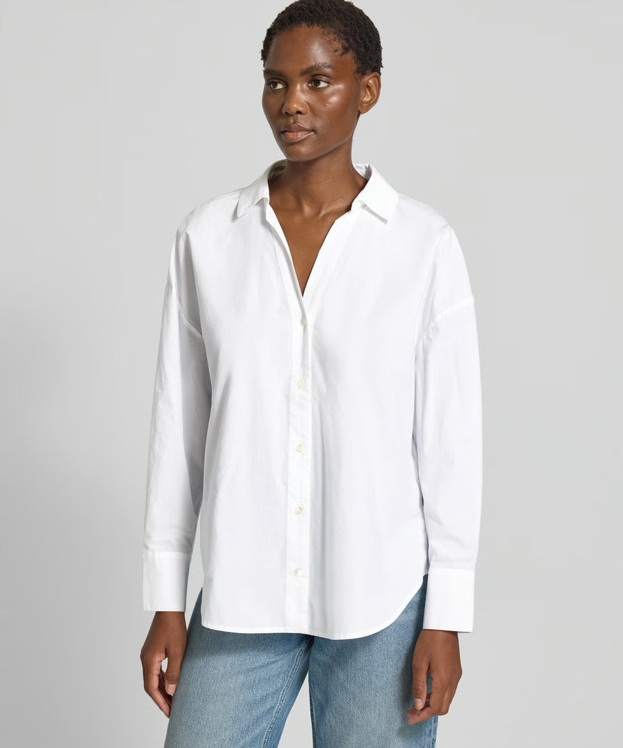 Model wearing the Lanius oversized white organic cotton shirt tucked into denim.