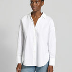 Model wearing the Lanius oversized white organic cotton shirt tucked into denim.