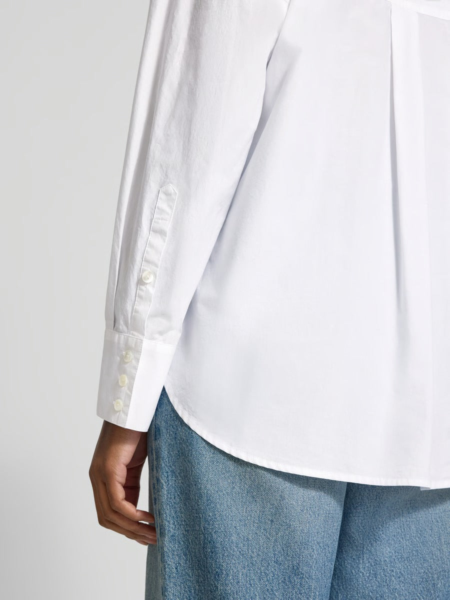 Close-up of the Lanius oversized white shirt showing the sporty button cuffs and the high-quality rounded hem finish