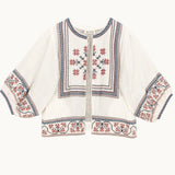 Mabe Apparel ecru cotton jacket featuring red and navy floral embroidery with wide puff sleeves.