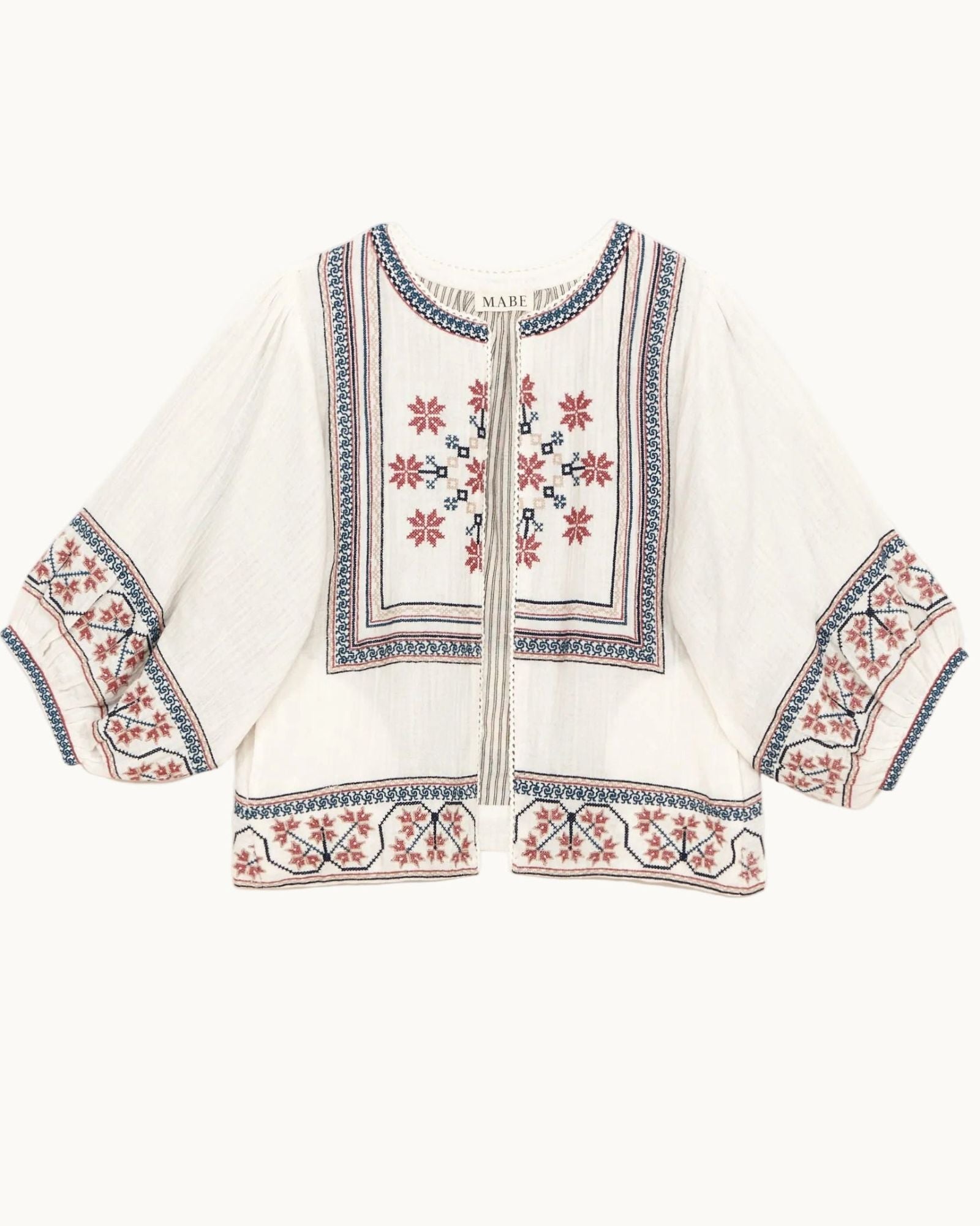 Mabe Apparel ecru cotton jacket featuring red and navy floral embroidery with wide puff sleeves.