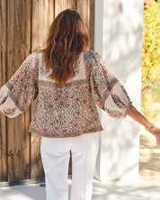 Back view of a woman outdoors wearing a Mabe Apparel bohemian printed puff sleeve cotton jacket.