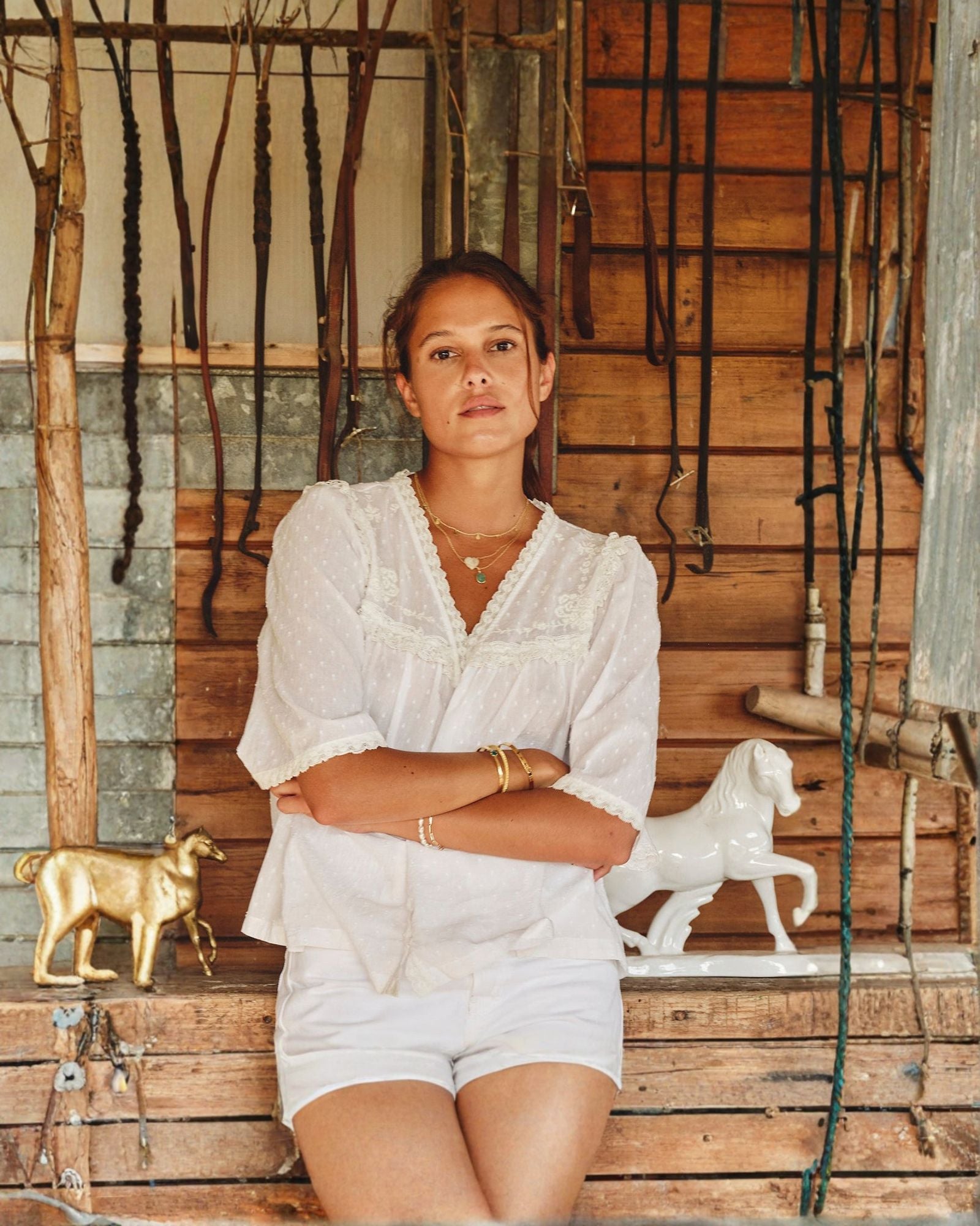 Model wearing white lace cotton blouse by Mabe Apparel in summer.