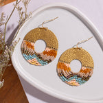 Close-up of Mayana Designs Earth fringe earrings, ombre Miyuki beads and hammered brass arch