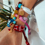 A Mediterranean summer stack of andana bracelets featuring the Aegean Blue Evil Eye. 