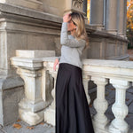 Woman wearing MICUIR Danseur de Roche black Mary Jane flats with a grey jumper and black skirt
