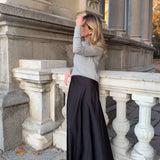 Woman wearing MICUIR Danseur de Roche black Mary Jane flats with a grey jumper and black skirt