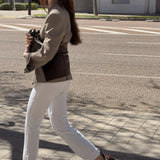 Woman walking in MICUIR Punky chocolate ankle boots with white jeans and a blazer