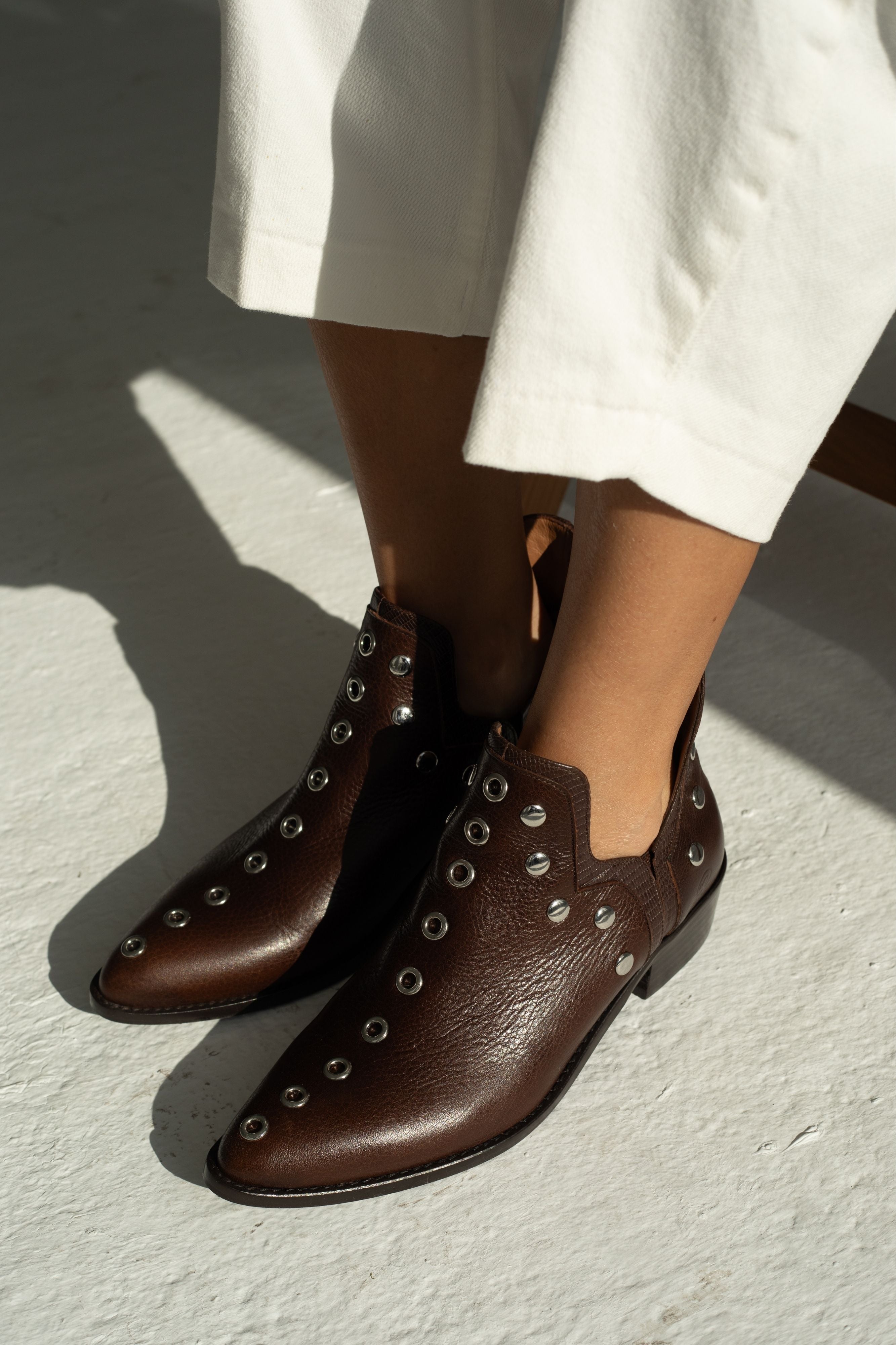 MICUIR Punky chocolate studded ankle boots worn with cream trousers