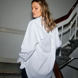 Model wearing MMEnola Shirt in White, side view with relaxed fit