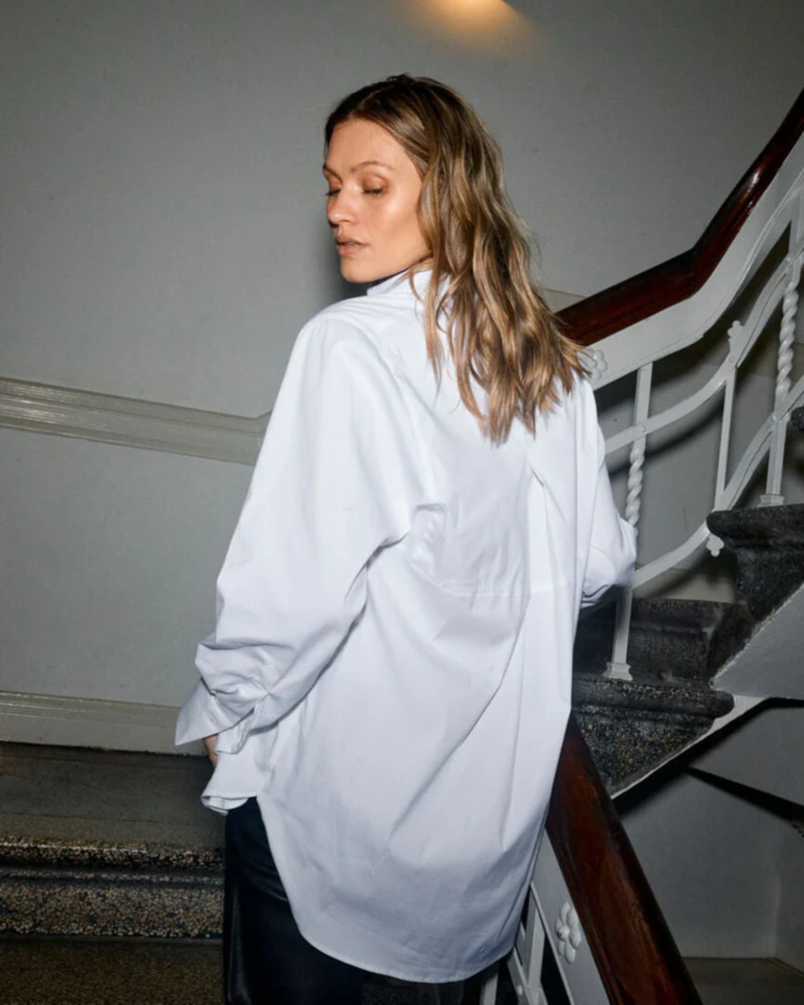 Model wearing MMEnola Shirt in White, side view with relaxed fit