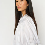 White MMTarima cotton blouse worn by model, angled side view