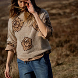 MOS MOSH Drea Popli round-neck jumper with brown jacquard roses on mottled beige, worn by a model, front view