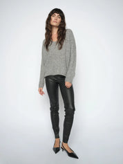 Woman wearing the  Mos Mosh MMSarina black leather leggings styled with a grey knit and black pointed heels.
