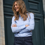 Model wearing the slim-fit MOS MOSH MMTilda shirt in sky blue, styled with navy trousers.