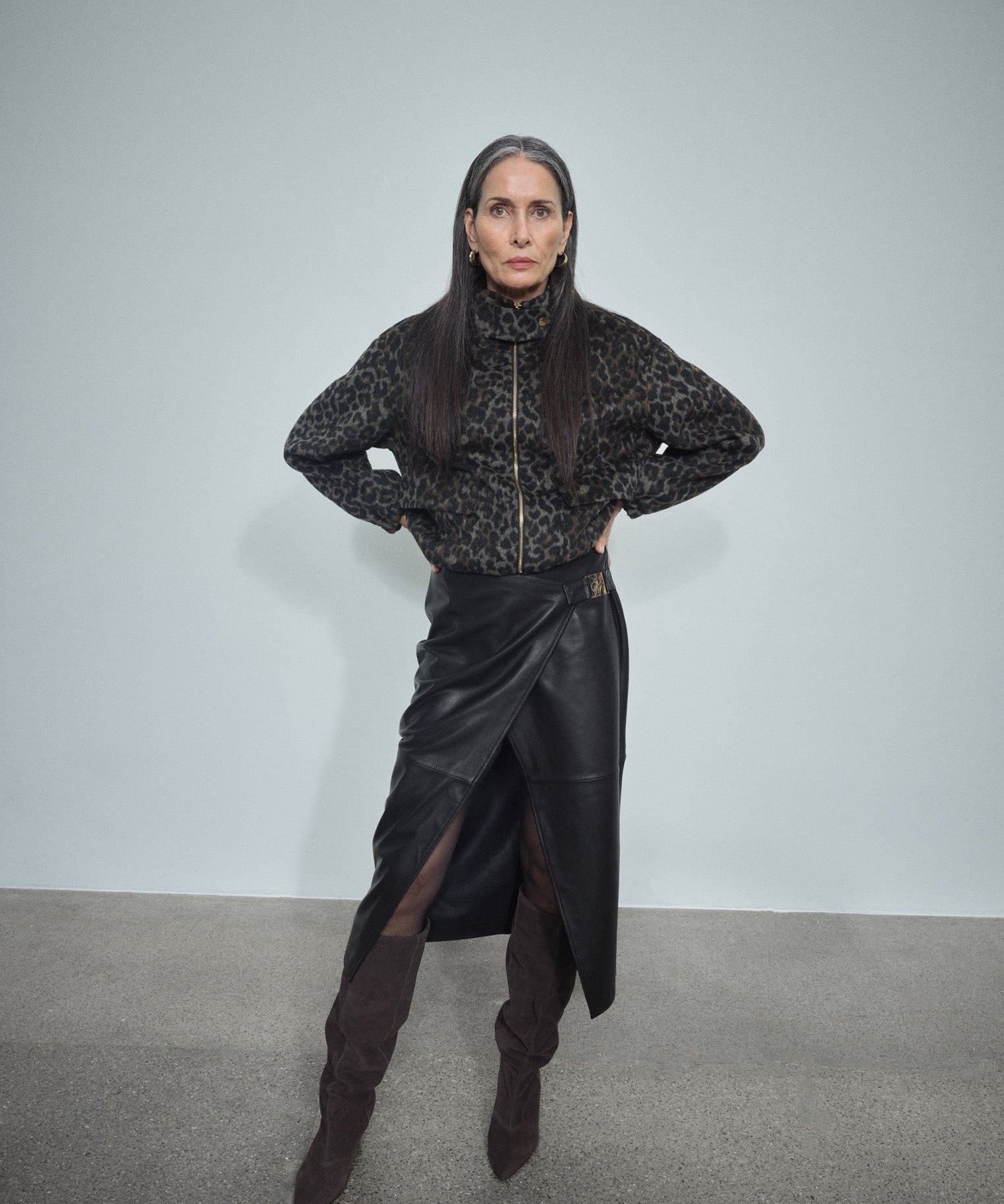 MOS MOSH Vela leather wrap skirt in black with a sculpted metal buckle, worn by a model, front view
