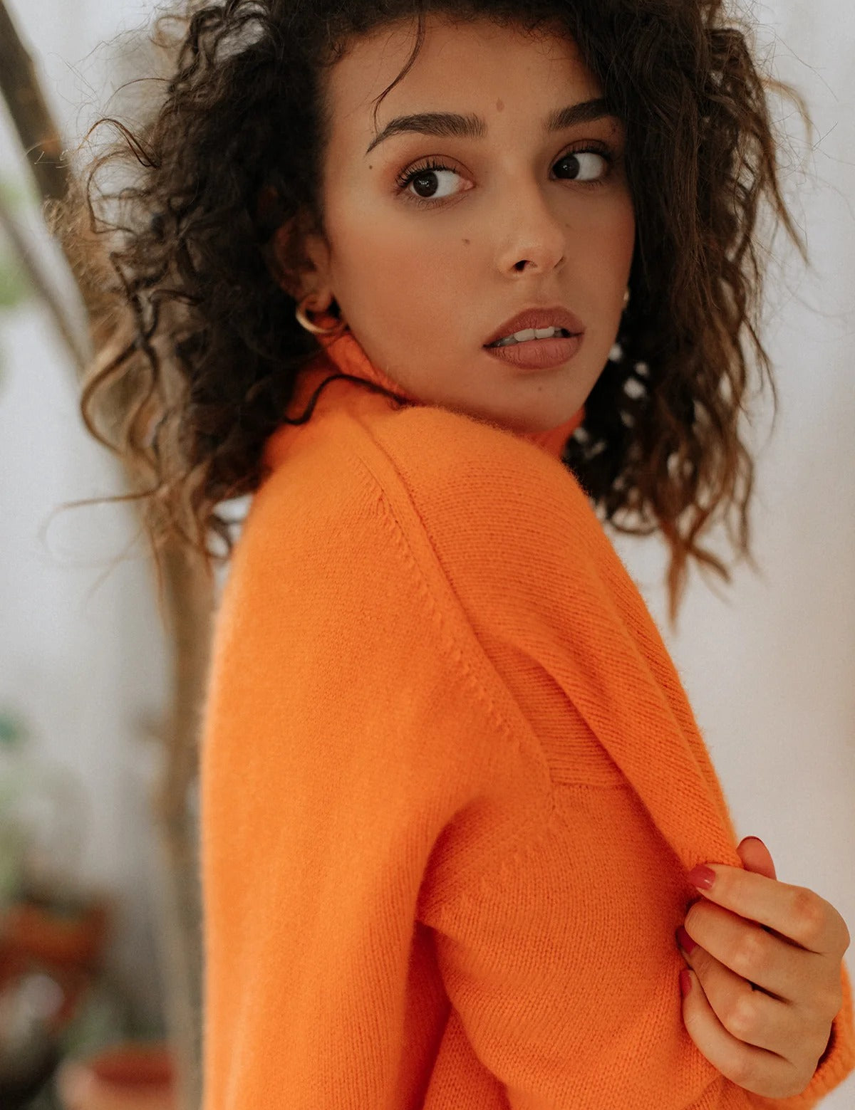 Close-up of the super soft 100% cashmere sweater texture and rich Arancia orange hue