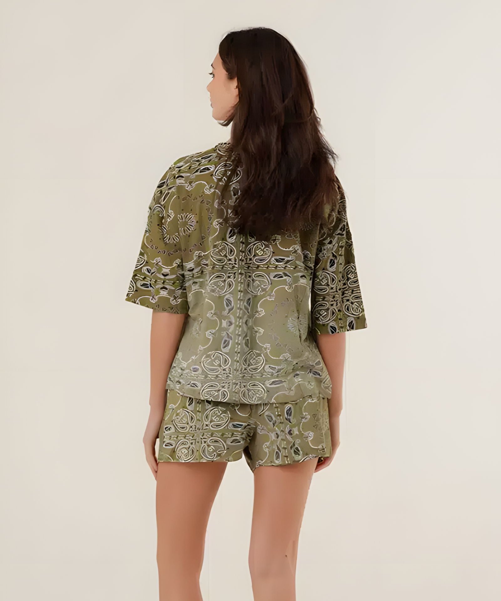 Rear view of the green bandana print shorts on a model, showcasing the comfortable casual fit and all-over vintage pattern.