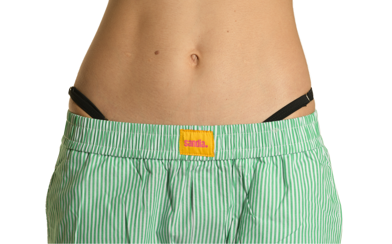 Close-up of the waistband of the Sandia green striped cotton wide-leg pants