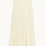 Mabe Apparel cream cotton maxi skirt with a smocked waistband and lace-trimmed hem.