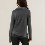 Rear view of the long-sleeve Tess fluid shirt in carbone charcoal, displaying its smooth fabric drape and classic collar setup.
