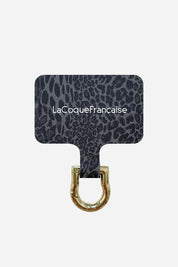 Close-up of the grey leopard phone chain connector patch featuring the gold metal attachment ring for phone chains