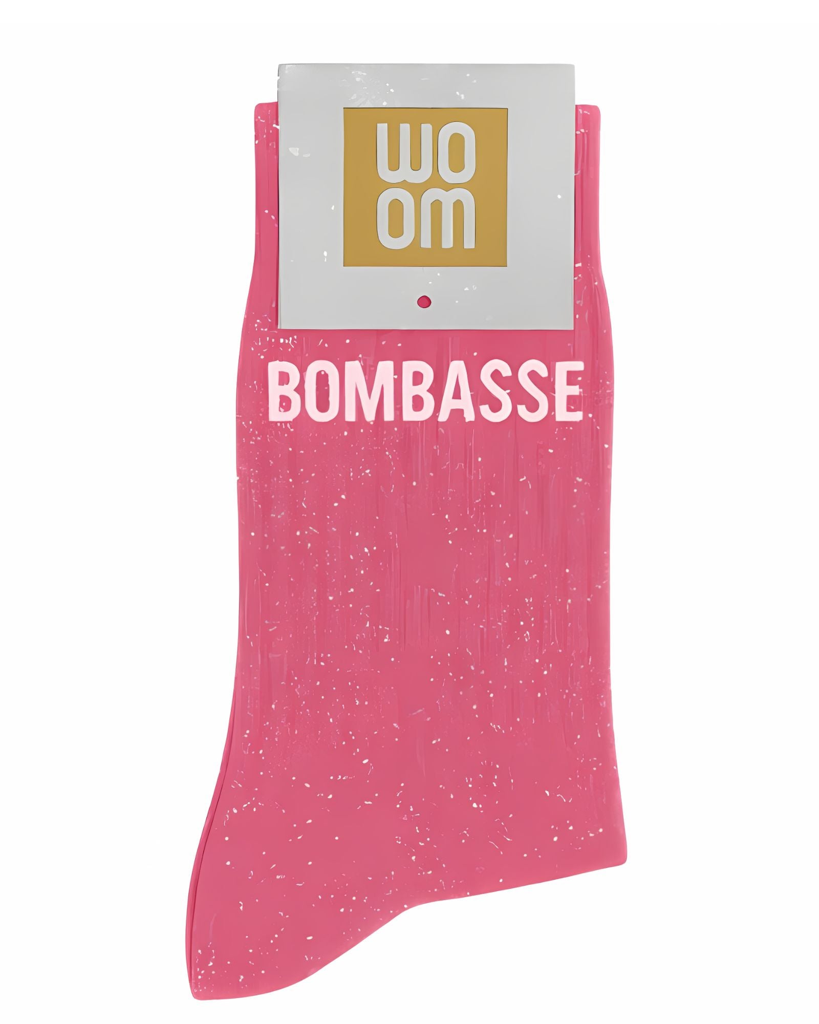 Bubble gum pink glitter message socks with a white jacquard BOMBASSE inscription at the ankle, presented in their original Woom paper packaging.