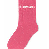 Side profile view of the bubble gum pink glitter sock showing the comfortable elasticated ankle and the bold white BOMBASSE wording detail.