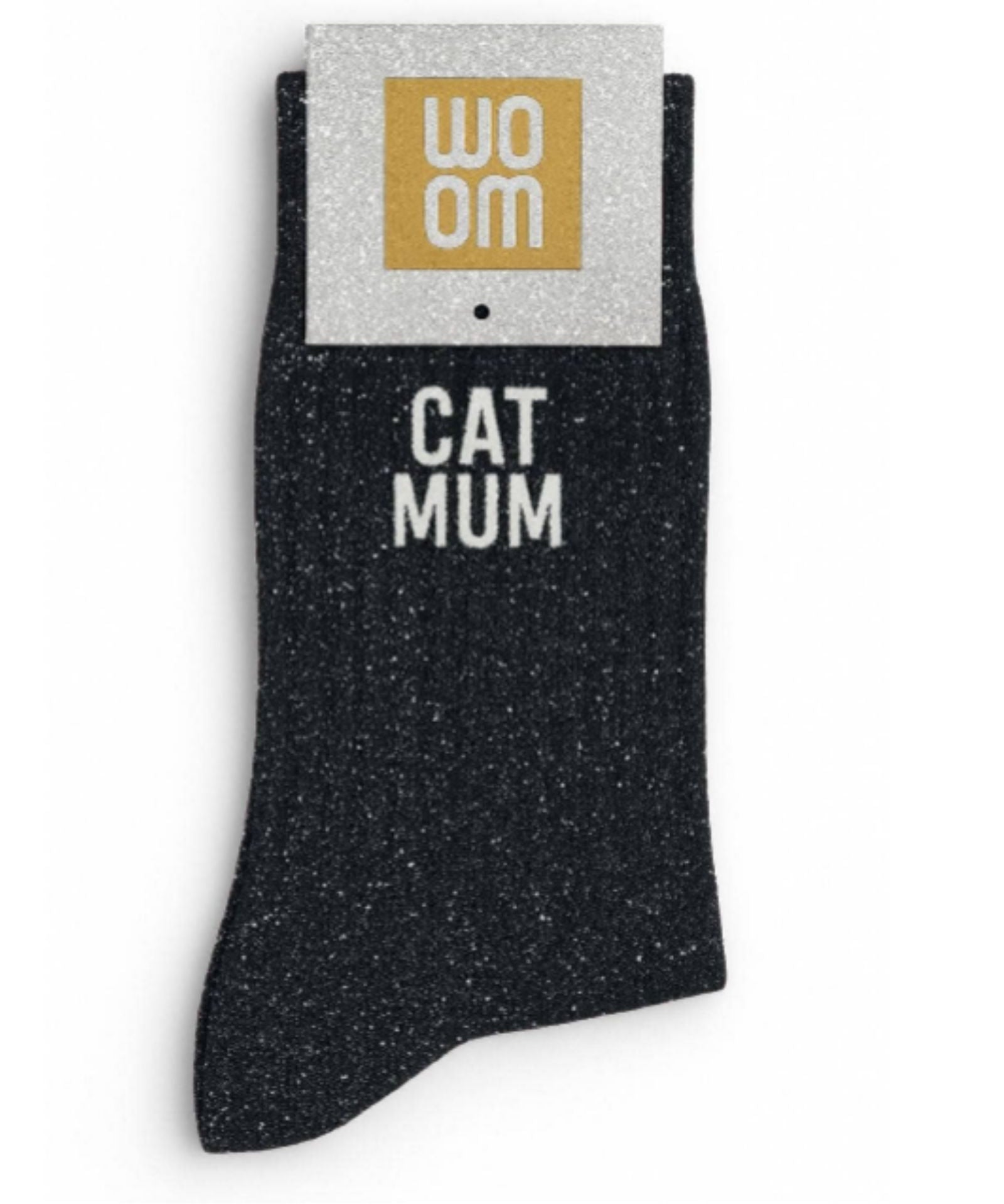 Classic black glitter message socks with a white jacquard CAT MUM inscription at the ankle, presented in their original Woom paper packaging.