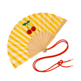 Close-up view of the opened yellow striped wooden fan, showcasing the vibrant cherry graphics, fabric texture, and attached red contrast cord.