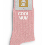 Lovely pink glitter message socks with a white jacquard COOL MUM inscription at the ankle, presented in their original Woom paper packaging.