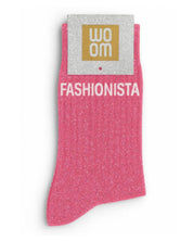 Vibrant pink glitter message socks with a white jacquard FASHIONISTA inscription at the ankle, presented in their original Woom paper packaging.