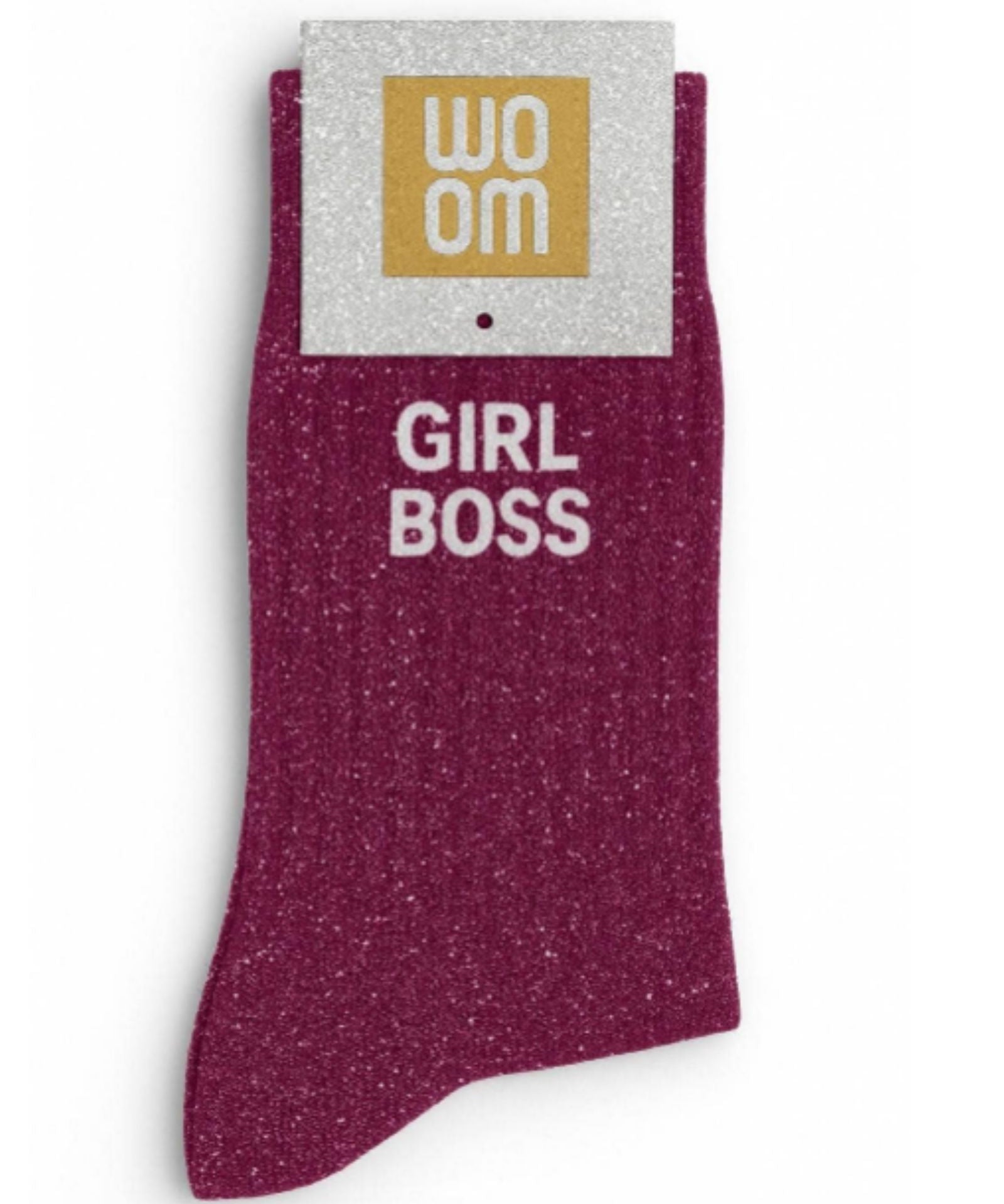 Rich wine-colored glitter message socks with a white jacquard GIRL BOSS inscription at the ankle, shown in their original Woom packaging.