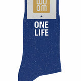 Deep blue glitter message socks with a white jacquard ONE LIFE inscription at the ankle, presented in their original Woom paper packaging.