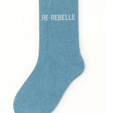 Side profile view of the turquoise glitter sock showing the comfortable elasticated ankle and the clean white REBELLE wording detail.