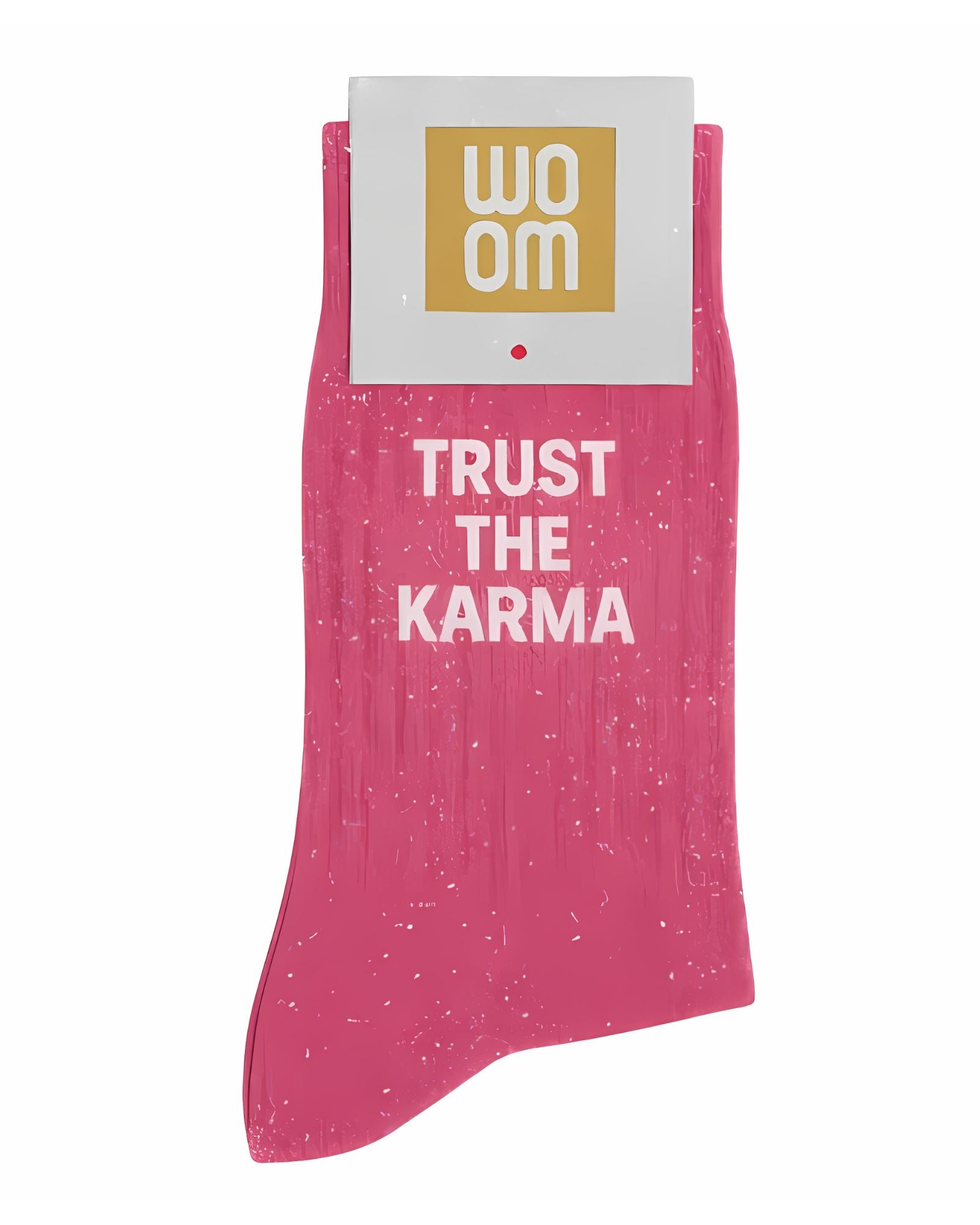 Vibrant pink glitter message socks with a white jacquard TRUST THE KARMA inscription at the ankle, presented in their original Woom paper packaging.